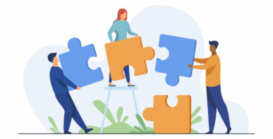 Partners holding big jigsaw puzzle pieces